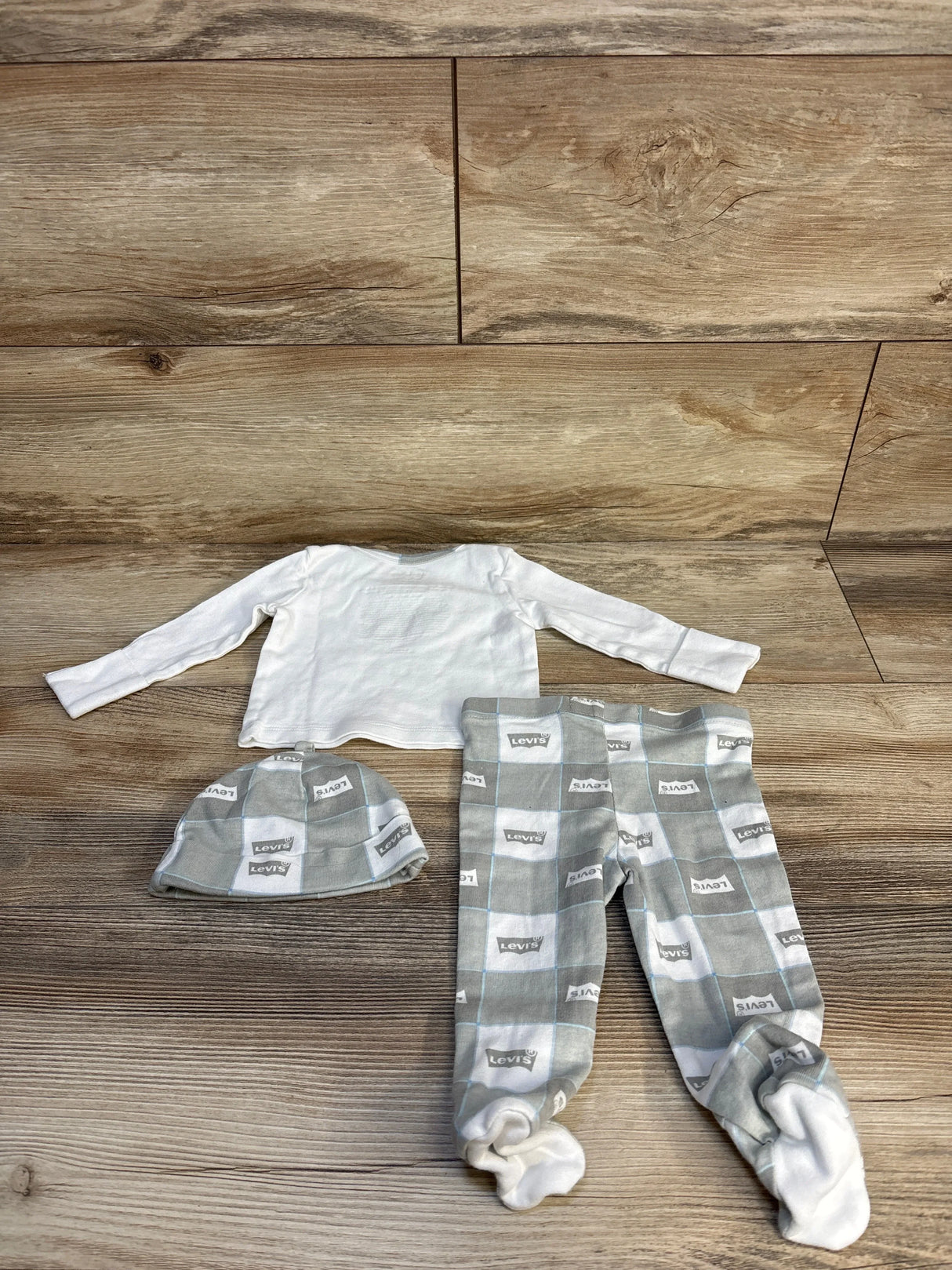 Levi's baby outfit with long sleeve white shirt, grey checkered pants, and matching hat