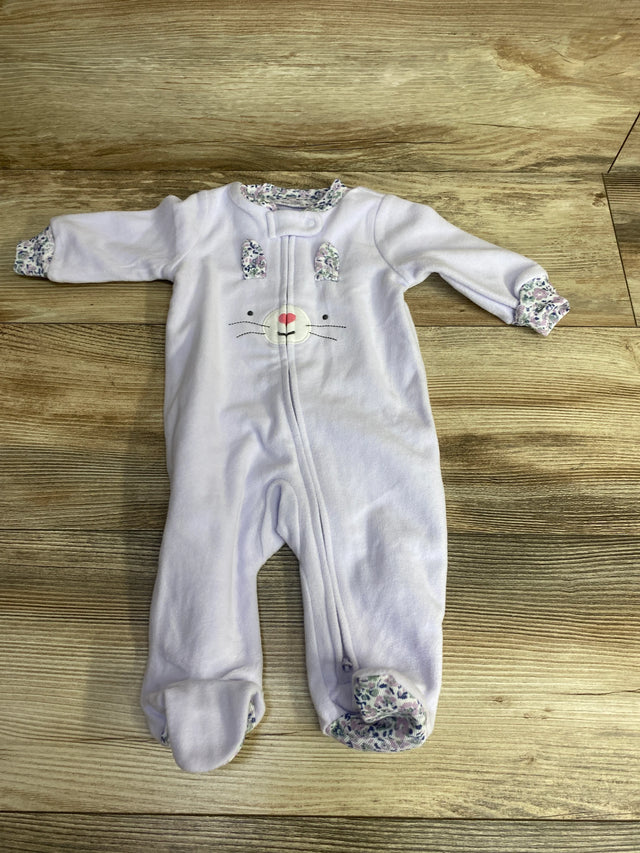 Light purple baby onesie with bunny face and floral trim on feet, cuffs, and collar on wooden floor