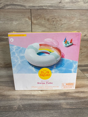 Front view of Sun Squad inflatable rainbow swim tube box showing rainbow tube graphic, built-in pillow and 41 in diameter label on wood floor