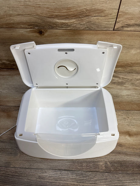White baby wipe warmer with open lid on wood floor, ideal for newborn care and diaper changes