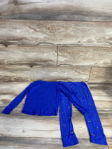 Flat lay of Carter's navy 2-piece toddler pajama set with long-sleeve top and matching pants with small embroidered accents on wood background