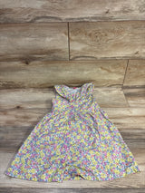Top-down view of Penelope Mack girls yellow floral button-front dress showcasing ruffled collar and front buttons on wood floor