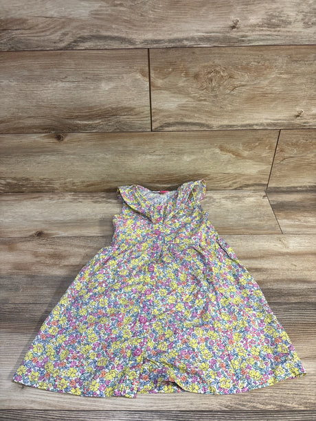 Top-down view of Penelope Mack girls yellow floral button-front dress showcasing ruffled collar and front buttons on wood floor