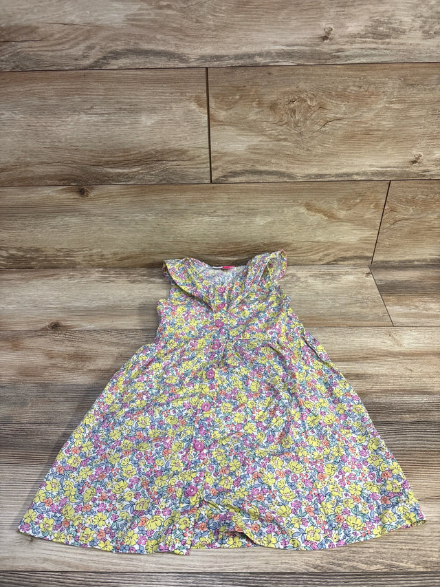 Top-down view of Penelope Mack girls yellow floral button-front dress showcasing ruffled collar and front buttons on wood floor