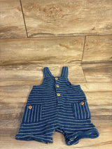 Flat lay of blue Cat & Jack striped henley shortalls showcasing front button placket and two patch pockets with wooden-look buttons on wood floor background
