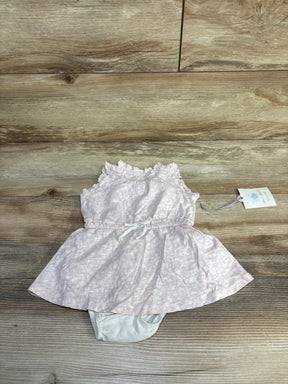 Flat lay of Cloud Island pink tank dress and white bloomers (0-3M) showing ruffled neckline and bow on wood background