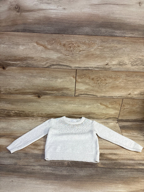 White Children's Place pullover sequin sweater for toddlers, size 3T, on a wooden background.