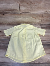Light yellow kids short sleeve button-up shirt on wood floor, ideal for baby or toddler clothing resale
