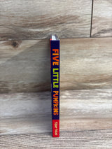 Five Little Pumpkins children's book by Tiger Tales, standing on wood floor