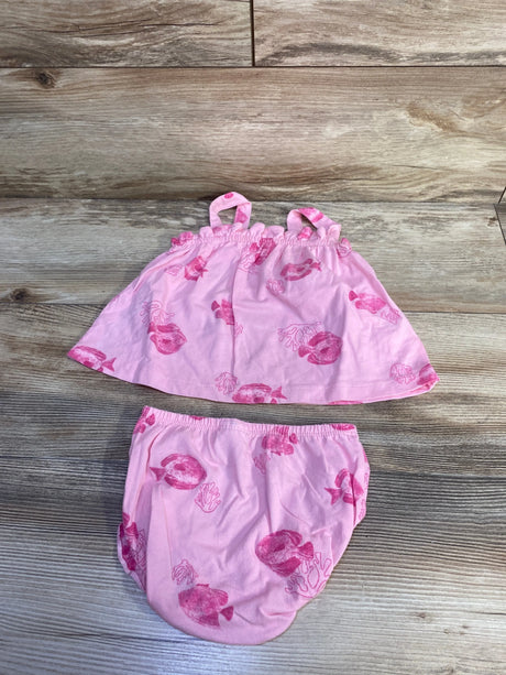 Top down view of pink tank top and bloomer set showcasing fish print and elastic waist and straps on wood background