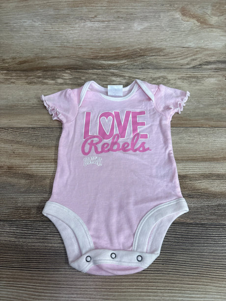 Flat lay of pink UNLV Love Rebels baby bodysuit showing ruffled cap sleeves and three snap closures on wood background