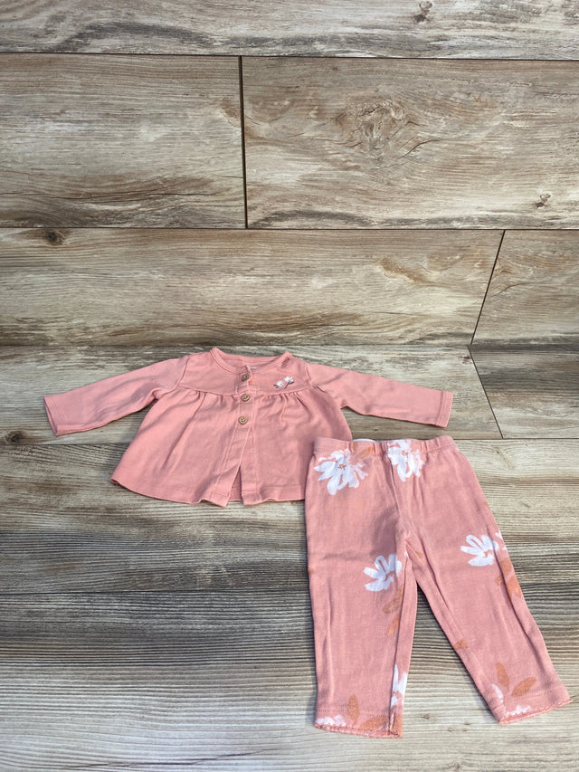 Pink baby outfit set with long sleeve top and floral pants on wood background