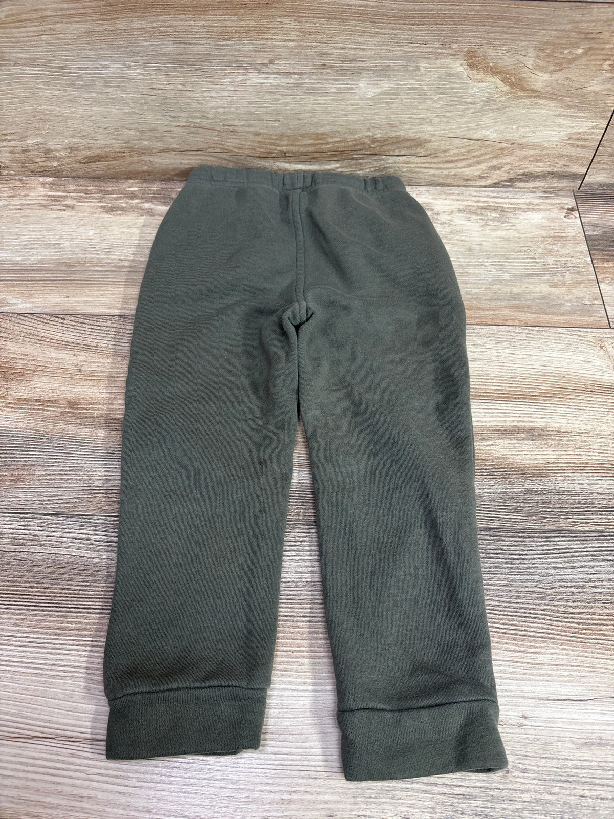 Lee drawstring joggers in green for toddlers size 3T on a wooden background
