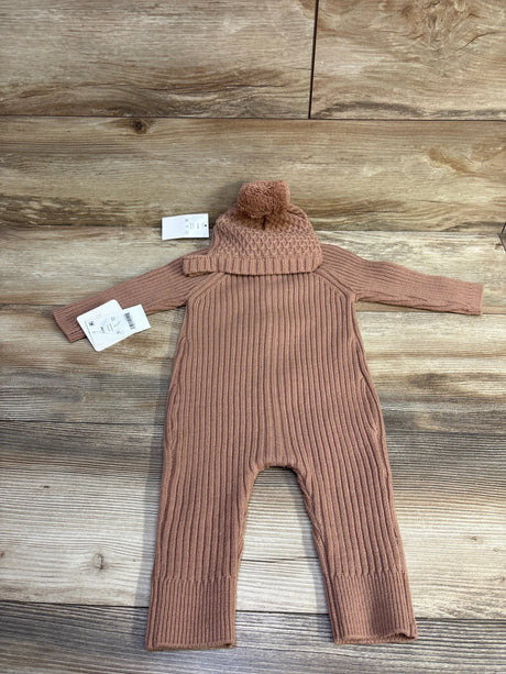 Flat lay of Grayson Mini 2pc knit button coverall and pom-pom hat showcasing ribbed knit texture on wood background, brown, size 3-6 months