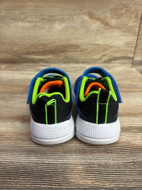 Rear view of Skechers Microspec Advance sneakers showcasing blue uppers, black panels, neon green accents, and white soles on wood
