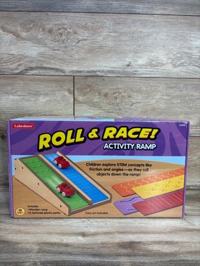 Front view of Lakeshore Roll & Race activity ramp box showing wooden ramp and colorful textured track inserts on wood backdrop