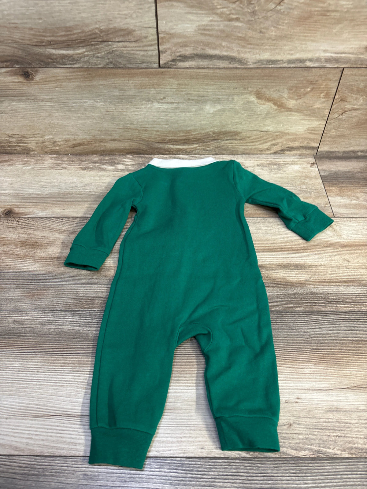 Green Nike collared zip coverall for infants in size 6m laid on a wood surface
