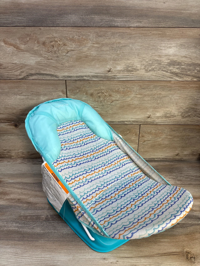Angled view of Summer Infant Foldaway two-position baby bather showcasing aqua headrest and patterned mesh seat on wood-plank background