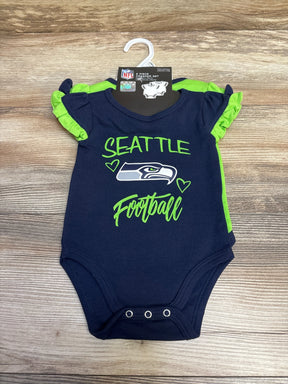 Navy and green 2-piece Seattle Seahawks baby creeper set with logo and ruffled sleeves on wooden background