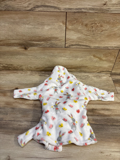 Flat lay of baby hooded bath robe showing pink and yellow butterfly print and hood on wood floor background