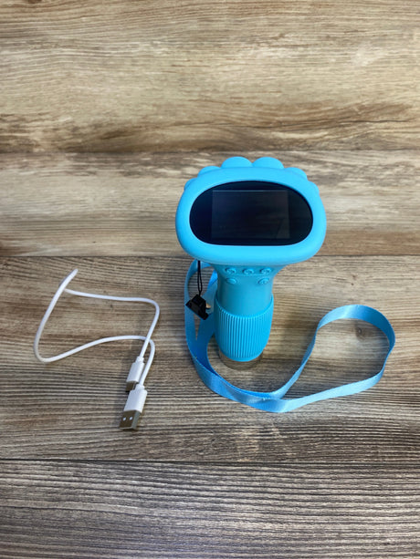 Blue kids digital camera toy with wrist strap and USB charging cable on wood surface