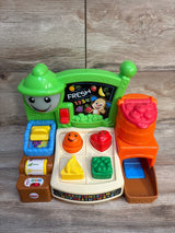 Front view of Fisher-Price Laugh & Learn market with shape-sorting fruit pieces, alphabet panel and FRESH 1234 sign