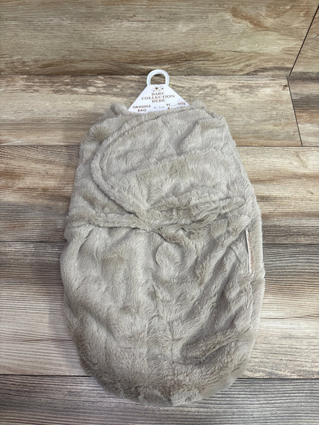 Front view of Blankets and Beyond tan plush swaddle wrap showcasing fuzzy texture and closed wrap design on wood grain
