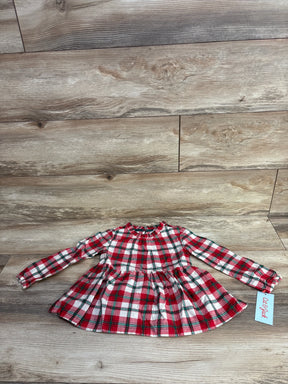 Red and white plaid long-sleeve toddler dress with ruffled collar on wood floor