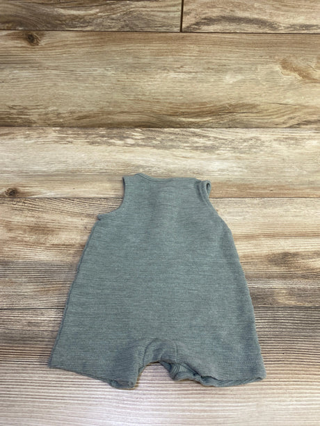 Front view of green newborn Henley romper showing sleeveless design and ribbed texture on a wood-grain background