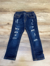Distressed dark wash kids jeans with elastic waistband on wood background
