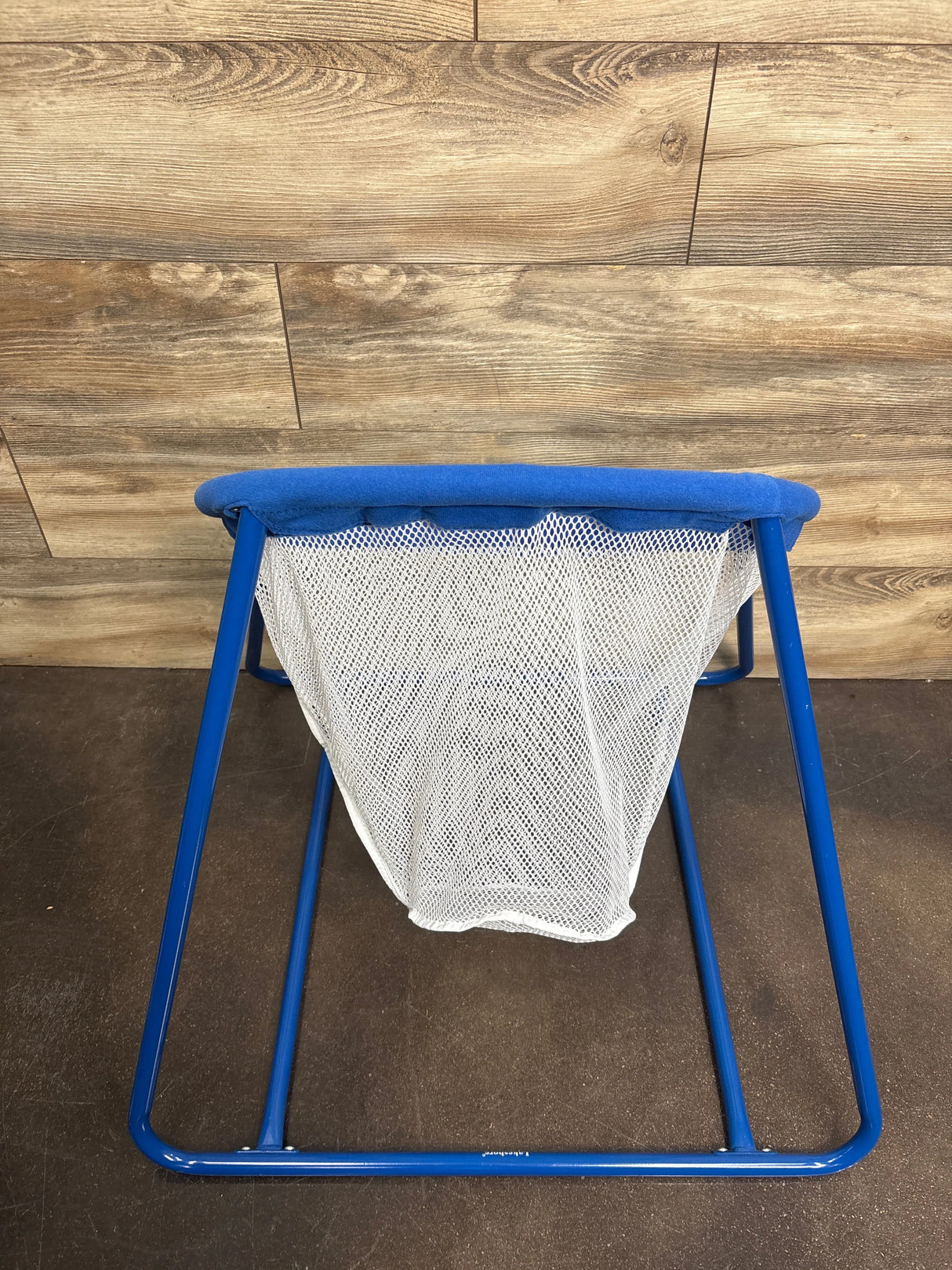 Front view of Lakeshore Learning Early Years Ball Toss Set with blue metal frame and white mesh net on wood floor