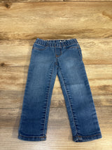 Blue denim jeans for kids with elastic waistband, displayed on wooden background