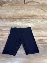 Flat lay of H&M navy toddler bike shorts size 4T showing elastic waistband and mid-thigh length on wood background