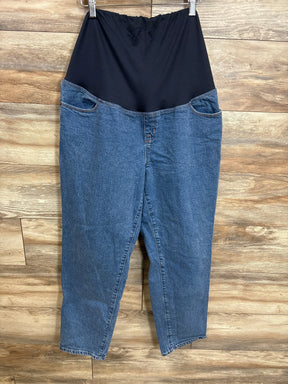Maternity jeans with black over-bump panel, blue denim, hanging on hanger against wood background