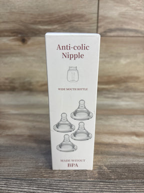 Anti-colic wide mouth baby bottle nipples made without BPA on wood background