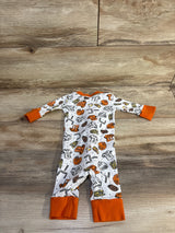 Flat lay of Magnolia Baby footless sleeper size 6 months showcasing orange-trimmed football print and fold-over cuffs on wood background