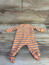 Front view of Carter’s orange and navy striped footed sleeper with long sleeves on a wood-look floor