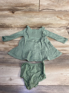 Sage green baby dress and bloomers set on wood background, long sleeve cotton outfit