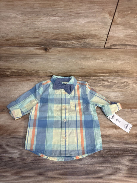 Top-down view of OshKosh 12M baby boys' long-sleeve plaid button-down shirt showcasing attached blue bow tie on wood floor