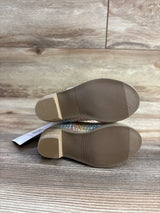 Bottom view of children's colorful glittery shoes on wooden floor, resale kids footwear