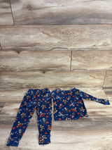 Blue Halloween-themed kids pajama set with cartoon characters on wood floor