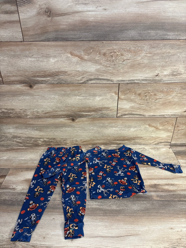 Blue Halloween-themed kids pajama set with cartoon characters on wood floor