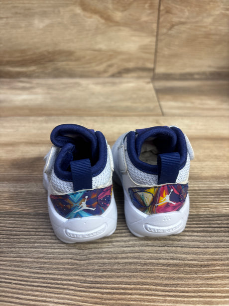 Rear view of Air Jordan Zion 2 GS Dynamic Turquoise sneakers showcasing colorful graphic heel panels and navy collars on a wood floor