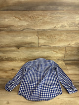 Flat lay of boys' blue-and-white gingham poplin button-down shirt showing long sleeves and curved hem on wood background