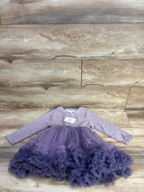 Flat lay of girls' purple ribbed long-sleeve dress (size 5T) showcasing layered tulle skirt and ruffled hem on light wood background