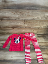 Pink long sleeve Minnie Mouse shirt and pink striped leggings kids clothing set on wood floor