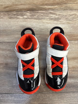 Kids' black and orange high-top sneakers with velcro straps on wood floor