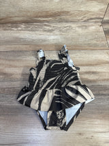Flat lay of Carter's brown smocked baby swimsuit with ruffle peplum, adjustable straps and snap crotch on wood background