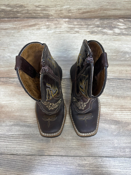 Top view of Texas Gold Minors brown square toe kids cowboy boots showcasing embroidered details and side zippers on a wood background
