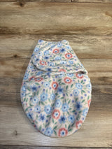 Floral fleece baby swaddle blanket with pink and blue flowers on wooden background